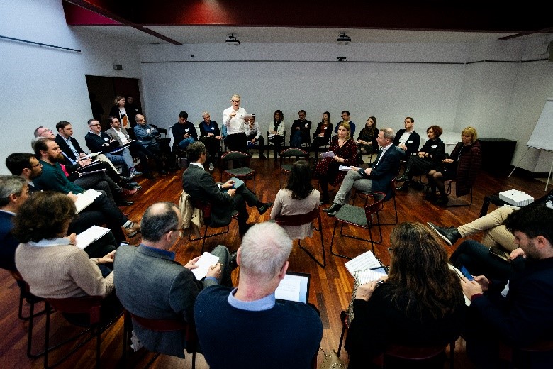 A group of people sitting in chairs

Description automatically generated